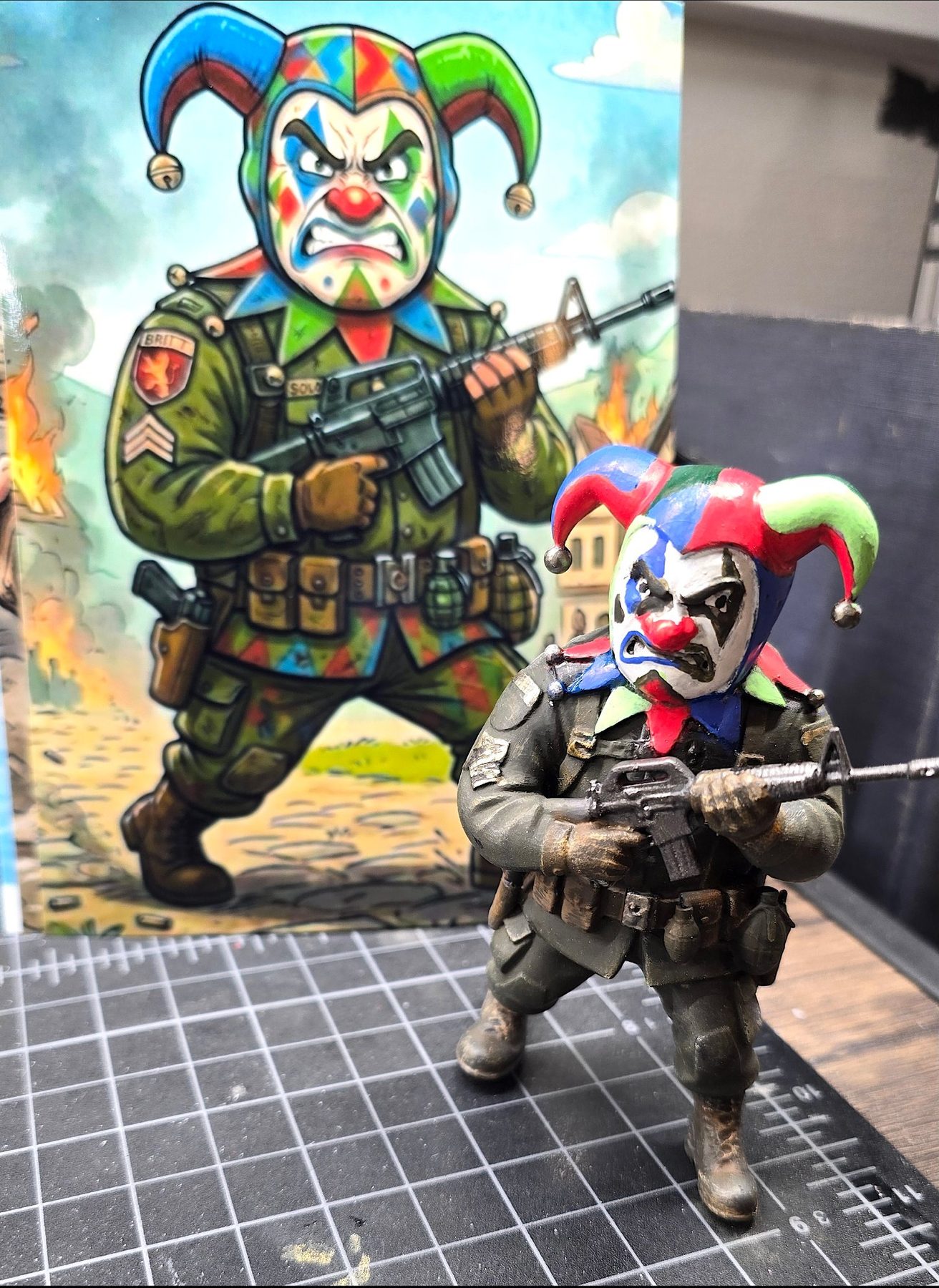 Jester soldier figurine beside its artwork