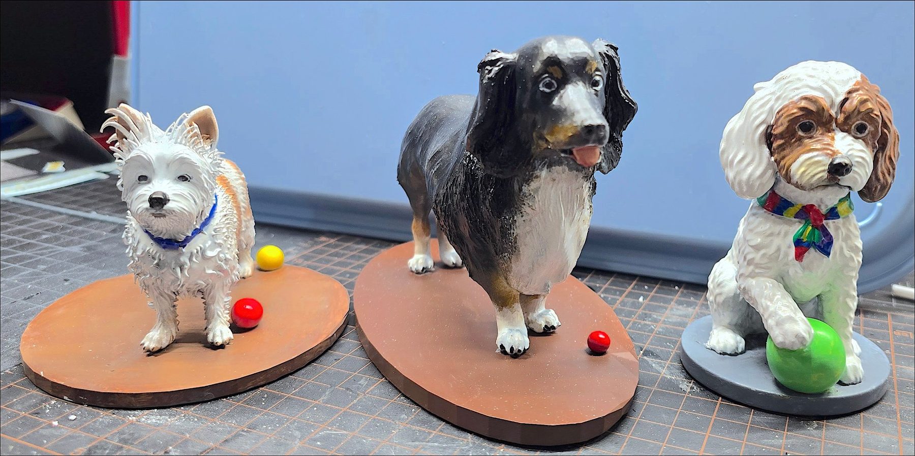 Three custom pet figurines: terrier, spaniel and cavapoo