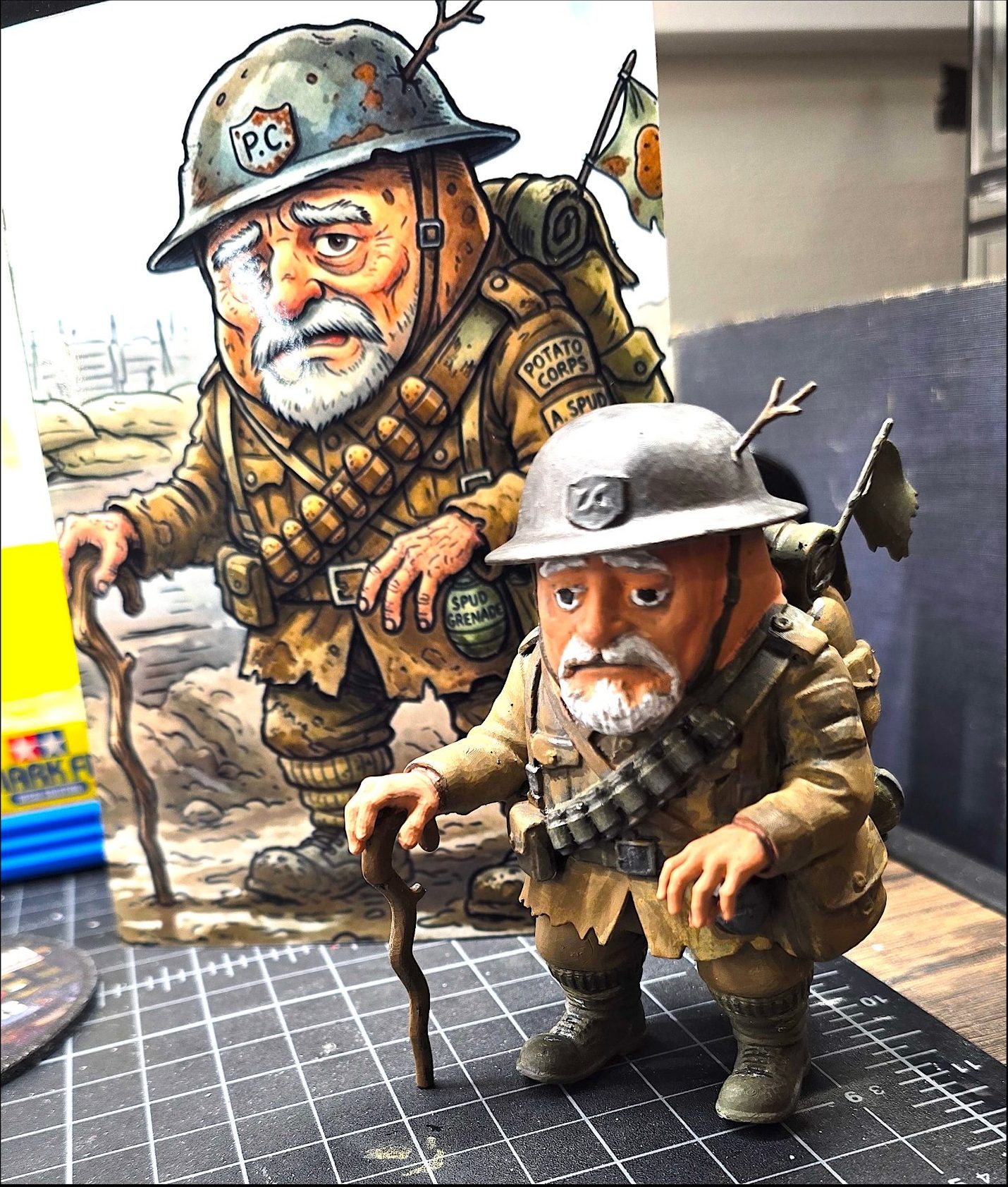 Potato Corps veteran figurine beside its artwork